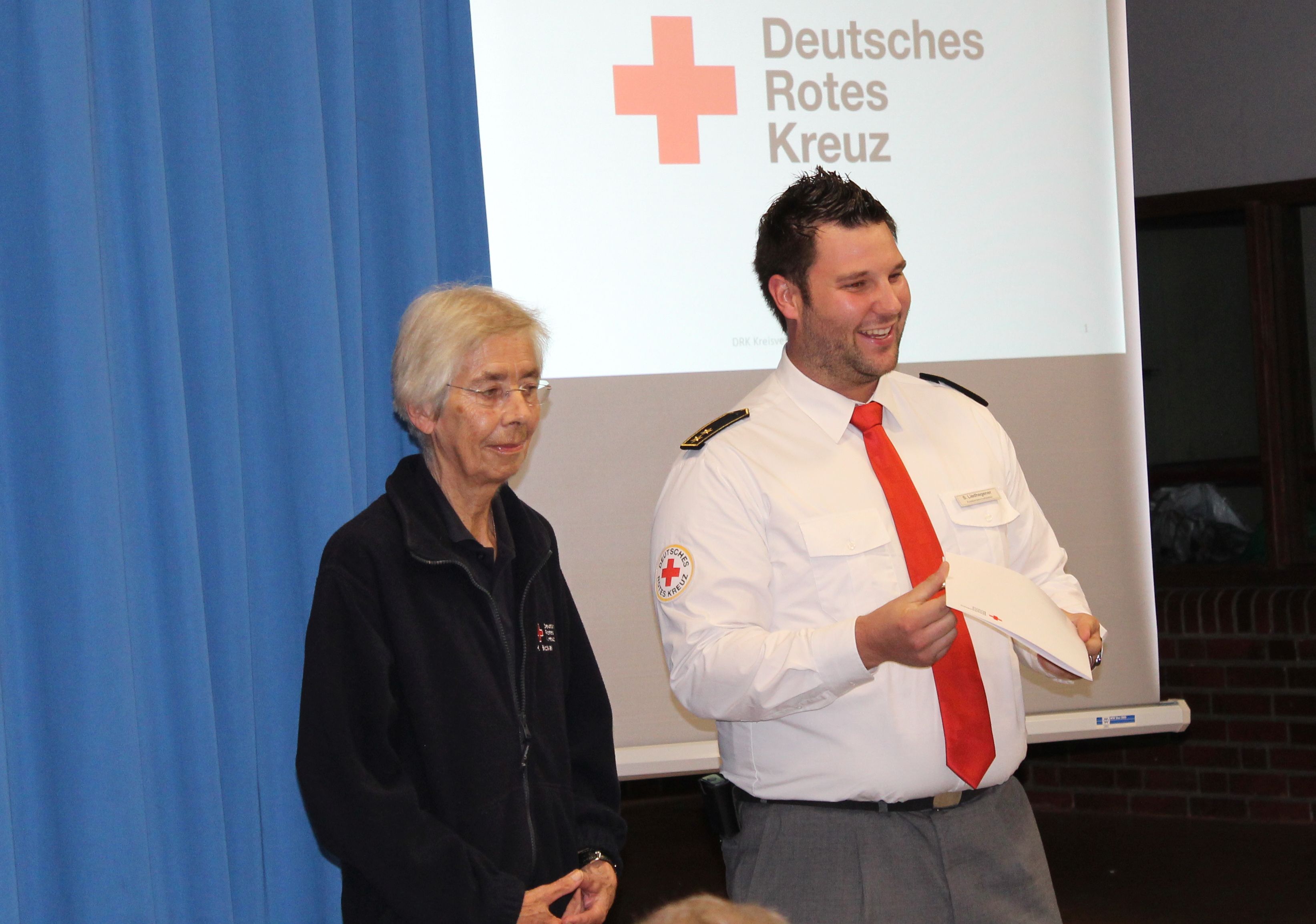 H. Bickel (links) wird geehrt von DRK-Kreisbereitschaftsleiter S. Liedhegener